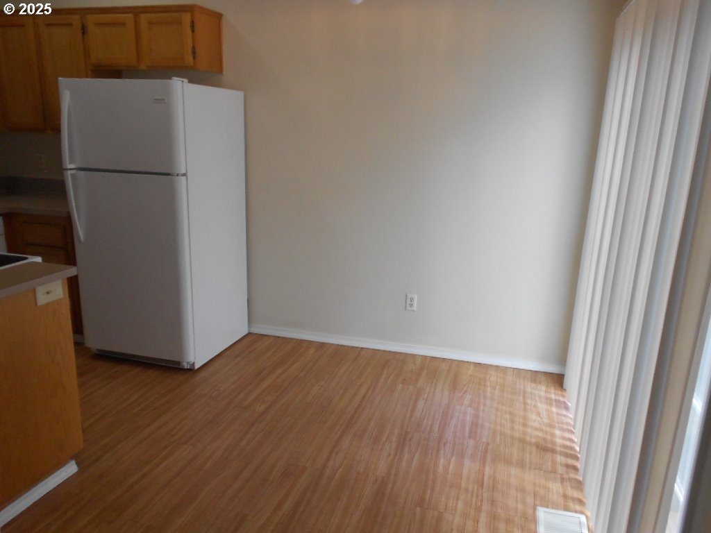 18440 Southwest Johnson Street Beaverton, OR 97003 - Photo 4 of 10 an empty room with wooden floor
