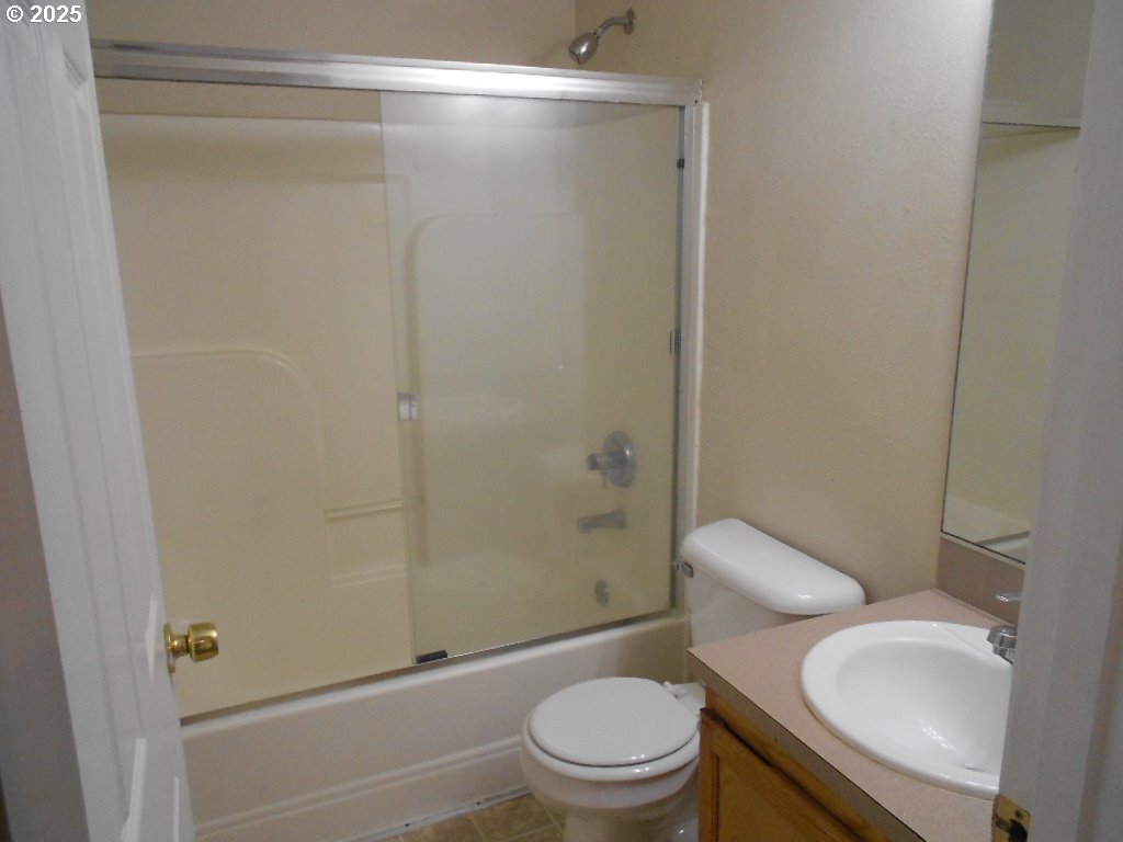 18440 Southwest Johnson Street Beaverton, OR 97003 - Photo 8 of 10 a bathroom with a granite countertop toilet and a shower