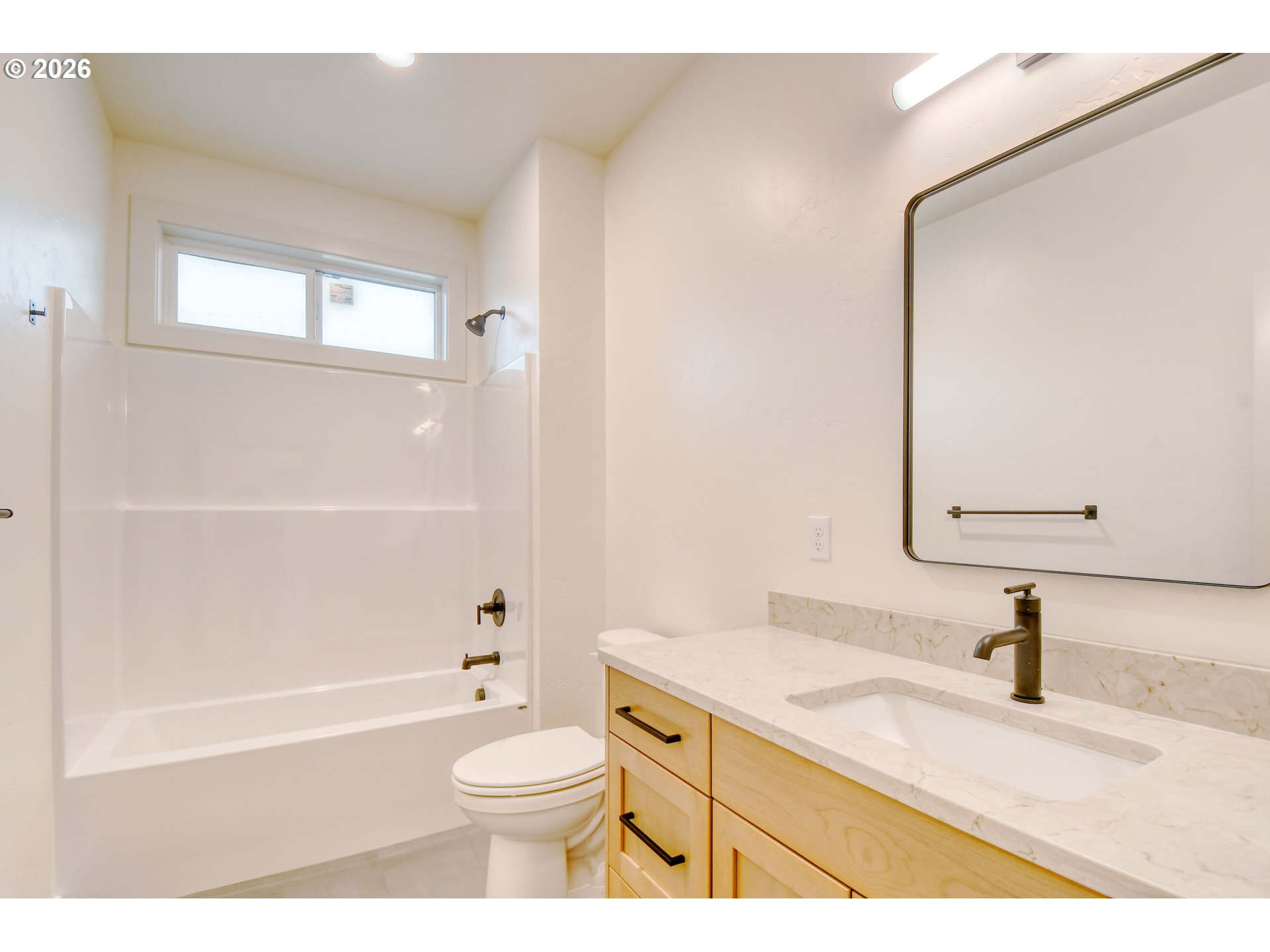 904 Southwest 43rd Street Pendleton, OR 97801 - Photo 30 of 46 a bathroom with a granite countertop sink toilet a mirror and bathtub