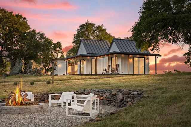a view of a large trees in front of a house