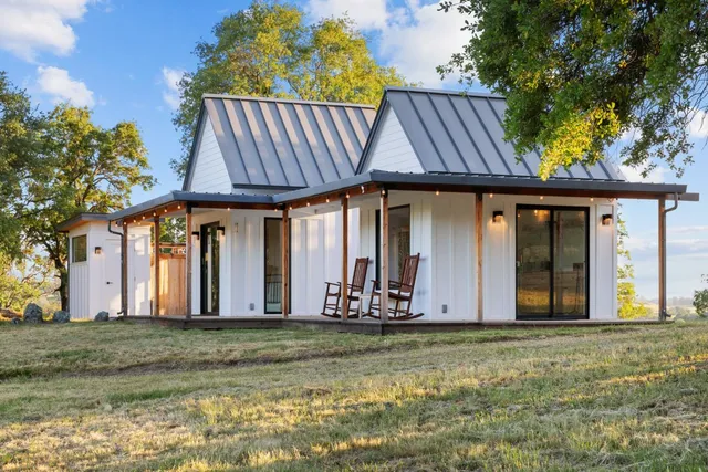 an aerial view of a house with garden space and sitting space