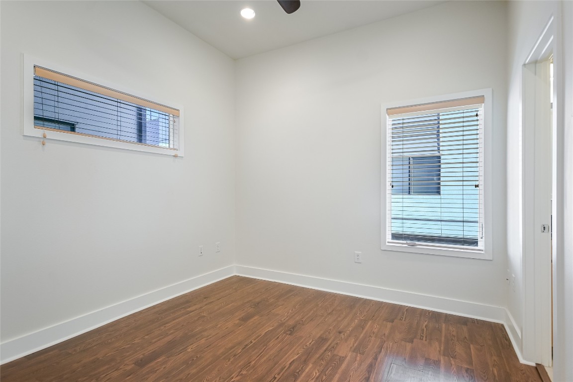 1702 South Lamar Boulevard, Unit 22 Austin, TX 78704 - Photo 19 of 30 a view of an empty room with wooden floor and a window