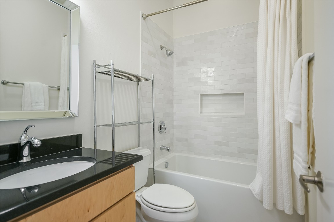 1702 South Lamar Boulevard, Unit 22 Austin, TX 78704 - Photo 20 of 30 a bathroom with a granite countertop sink toilet and shower