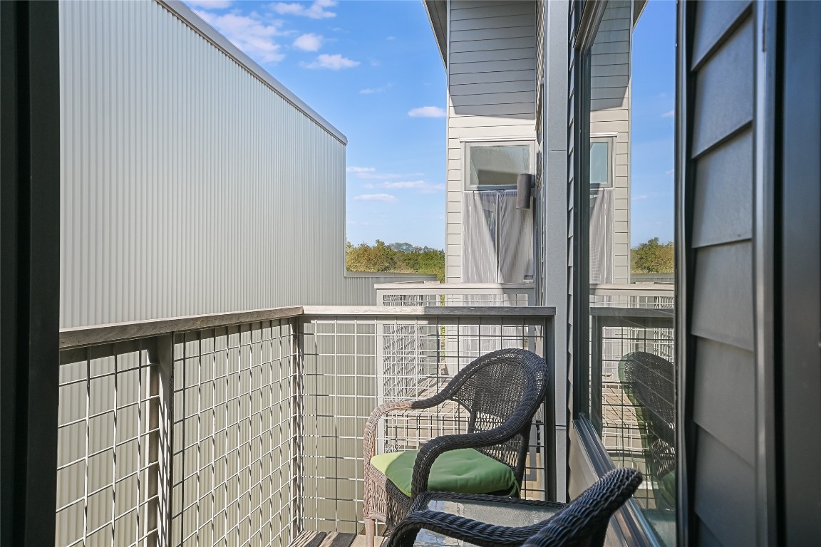 1702 South Lamar Boulevard, Unit 22 Austin, TX 78704 - Photo 23 of 30 a view of a balcony with chair and table