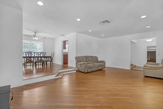 a view of a refrigerator in kitchen and an empty room