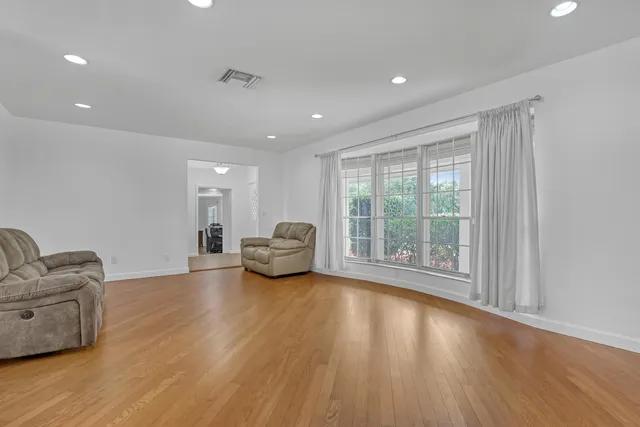 a kitchen with granite countertop a stove a sink cabinets and a refrigerator