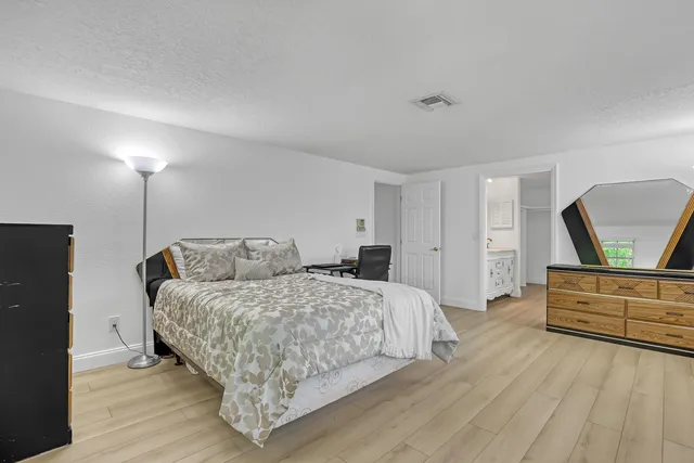 a bedroom with a bed and a table