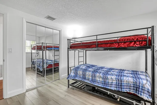 a view of a swimming pool with a garden and trees