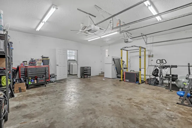 an aerial view of residential houses with outdoor space and swimming pool