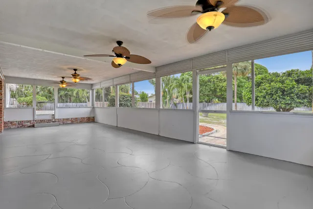 an aerial view of a house with a yard and lake view