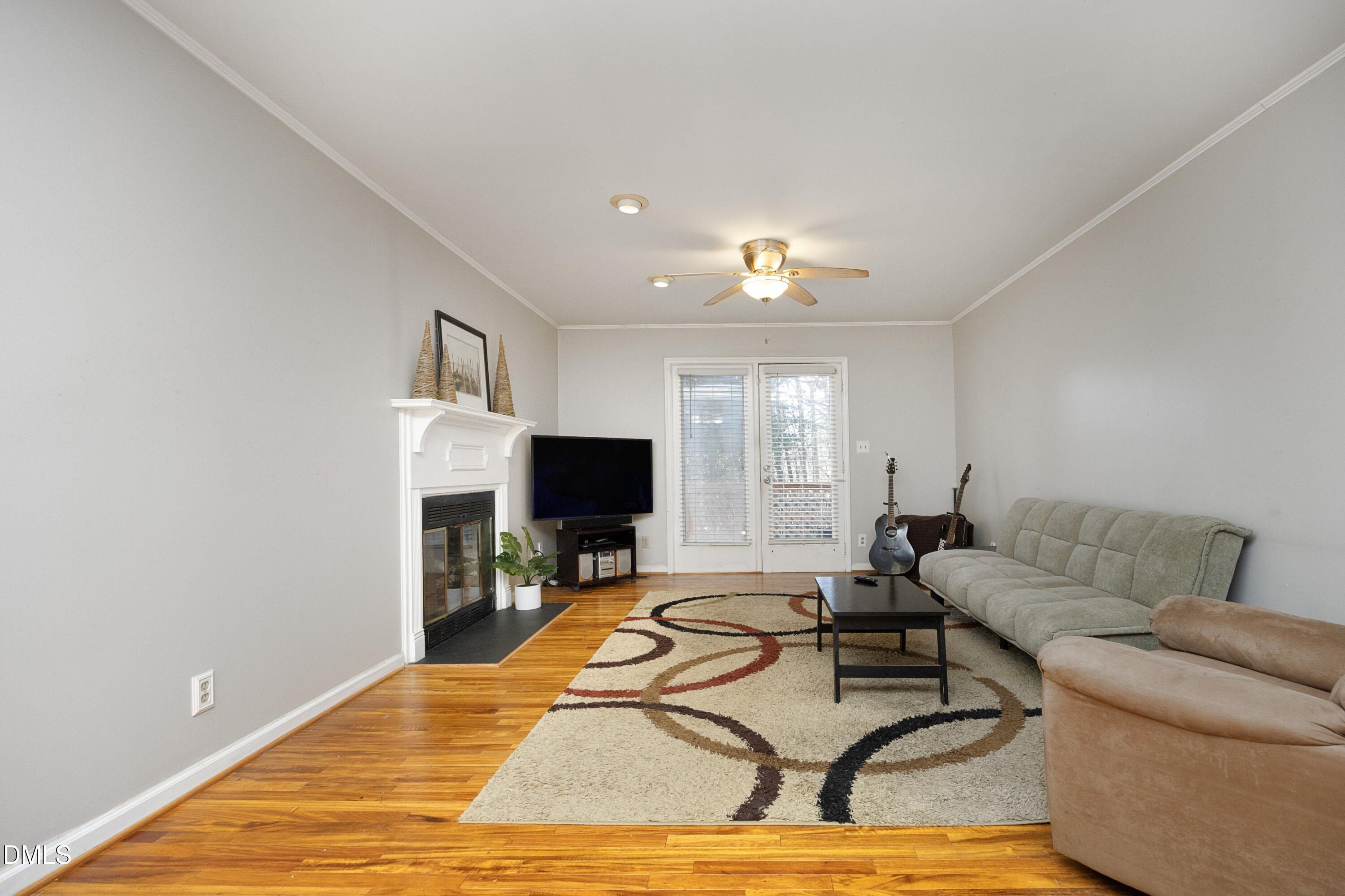 5544 Sharpe Drive Raleigh, NC 27612 - Photo 13 of 37 a living room with furniture and a flat screen tv