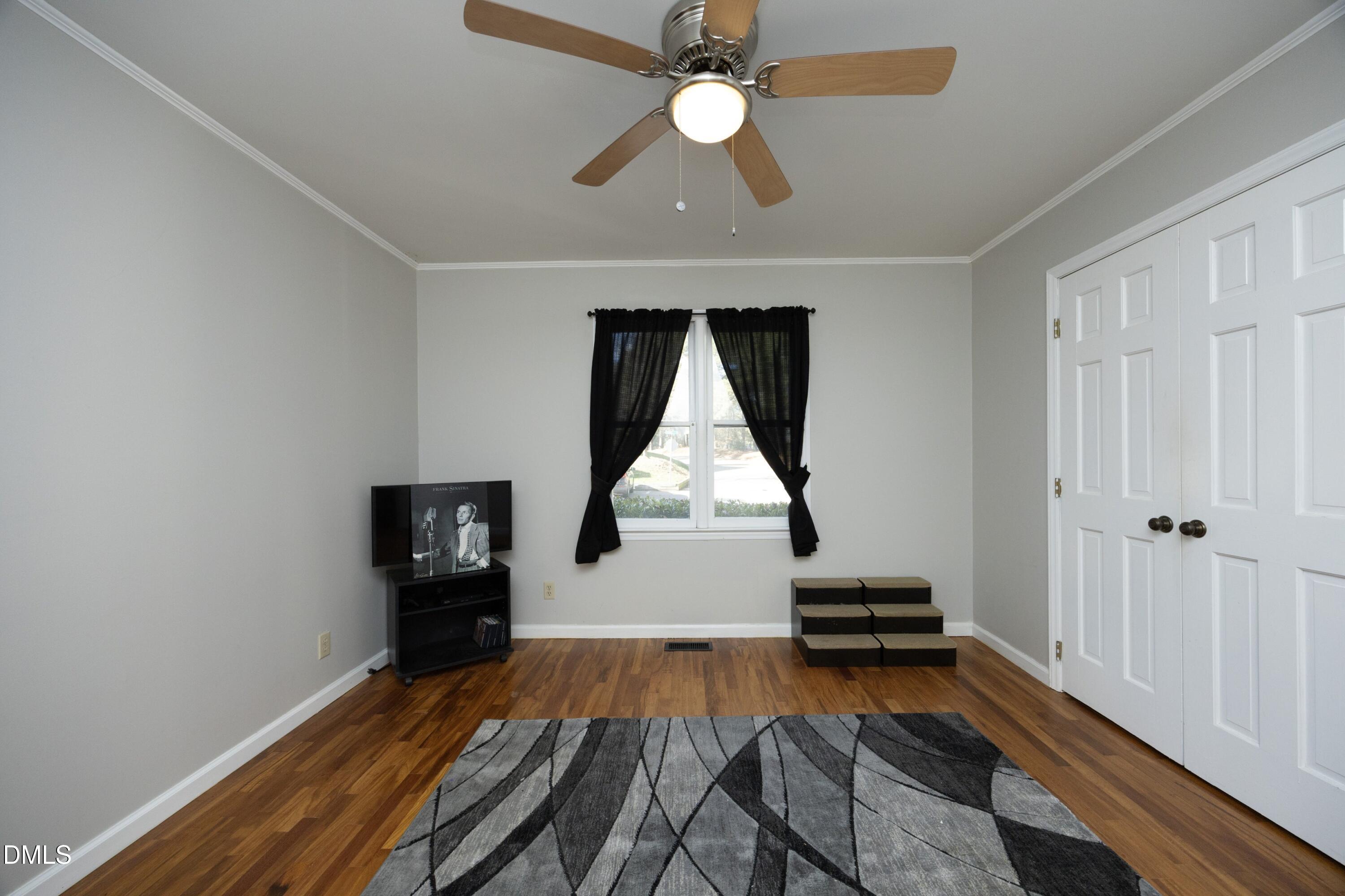 5544 Sharpe Drive Raleigh, NC 27612 - Photo 22 of 37 wooden floor with a bed and a window
