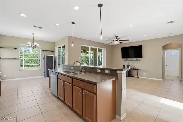 a kitchen with stainless steel appliances granite countertop a sink and a stove