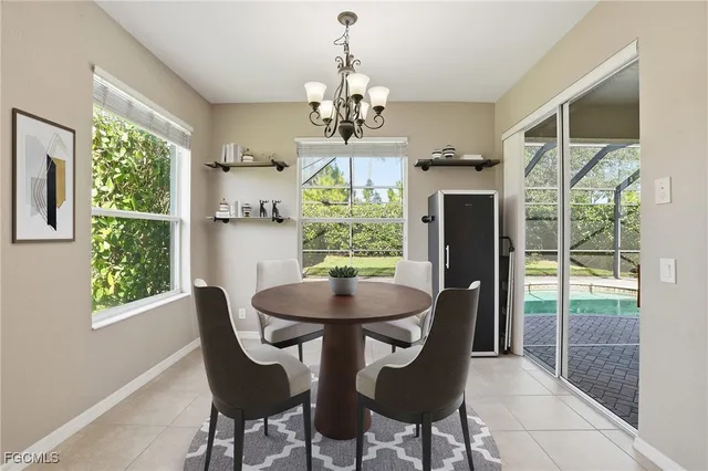 a dining room with furniture a chandelier and window