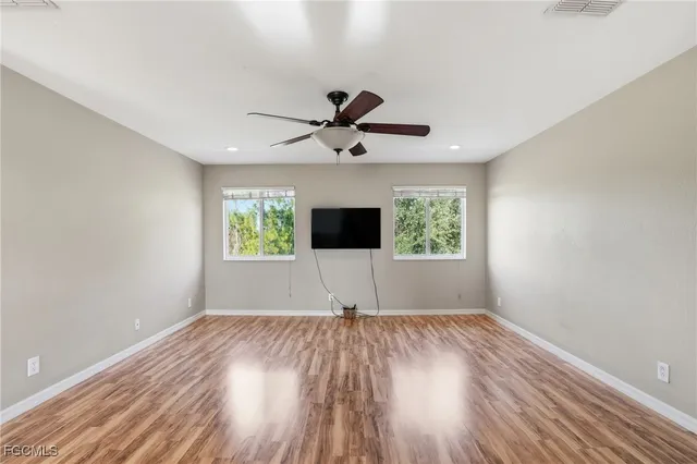 wooden floor in an empty room with a window