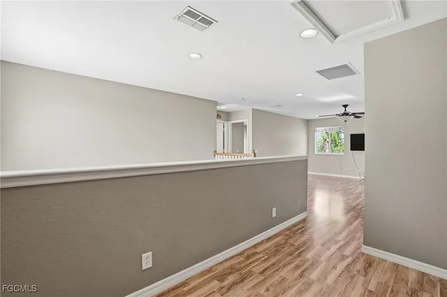 a view of a hallway with wooden floor