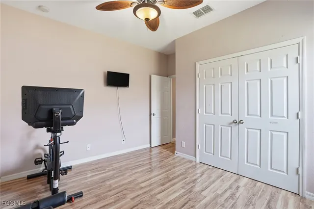 a view of a livingroom with a flesh screen tv and wooden floor