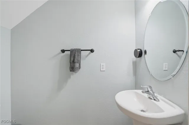 a bathroom with a sink and mirror