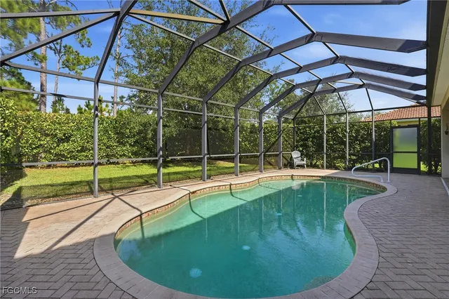 a view of a swimming pool with a yard in front of it