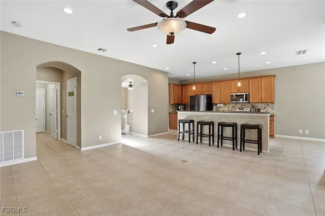 an open kitchen with a table and chairs