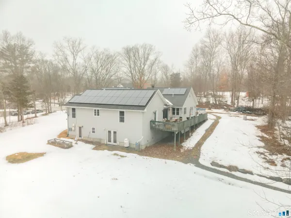 a view of a house with snow on the background