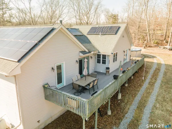 a view of a house with backyard and sitting area