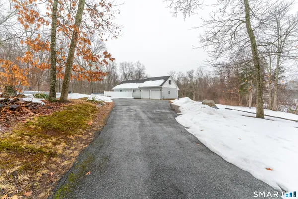 a view of a yard with snow on the road