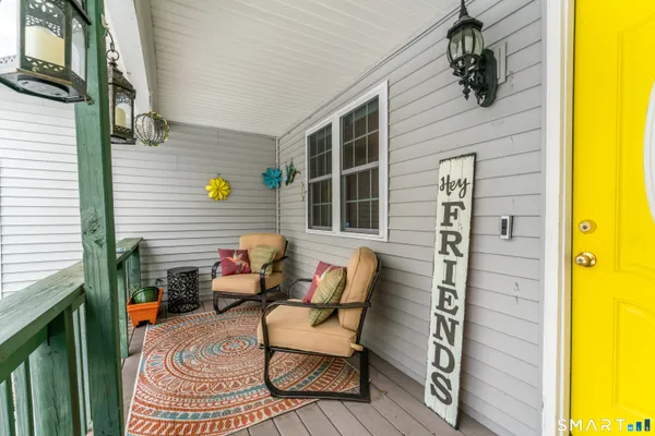 a balcony with table and chairs