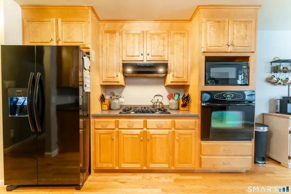 a kitchen with granite countertop a refrigerator and a stove