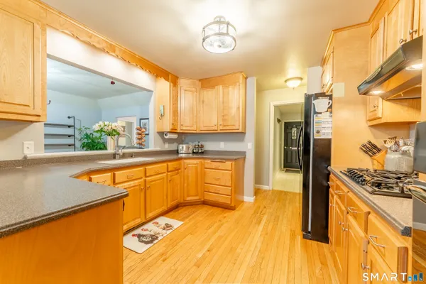 a kitchen with stainless steel appliances granite countertop a sink and cabinets