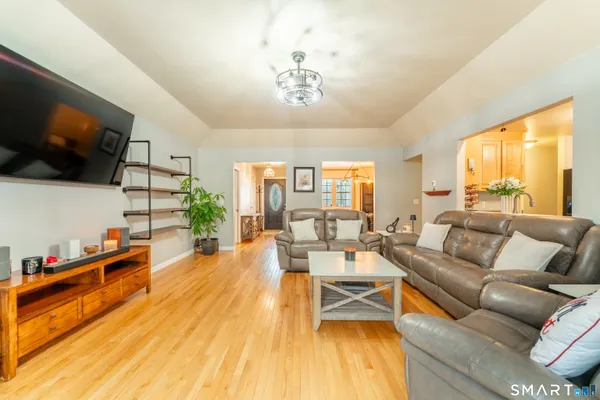 a living room with furniture a flat screen tv and a large window