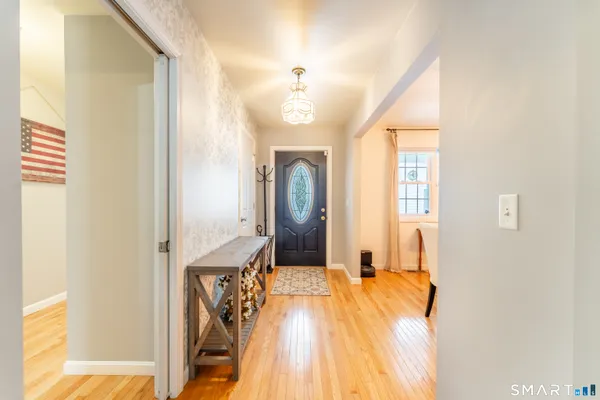 a bedroom with a bed mirror and a window