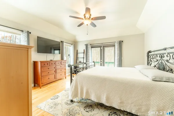 a bedroom with a bed and a flat screen tv