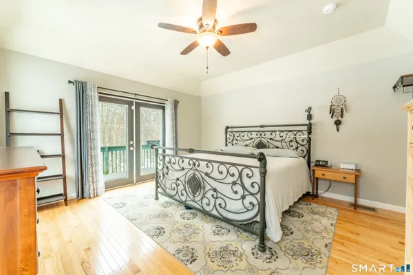 a view of a bedroom with furniture and wooden floor