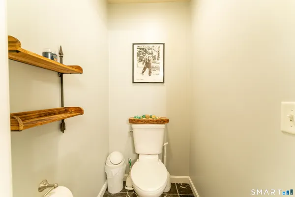 a white toilet sitting next to a bathroom sink