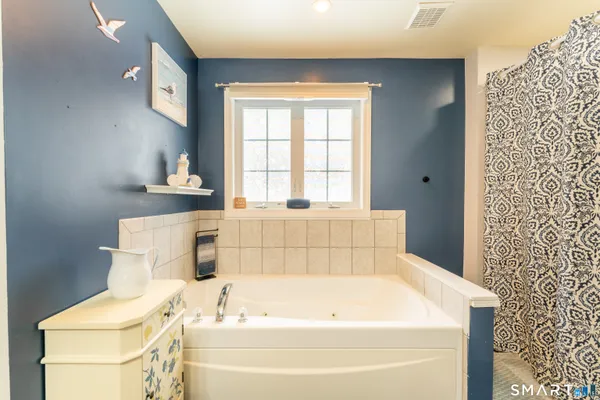 a bathroom with a bathtub and sink