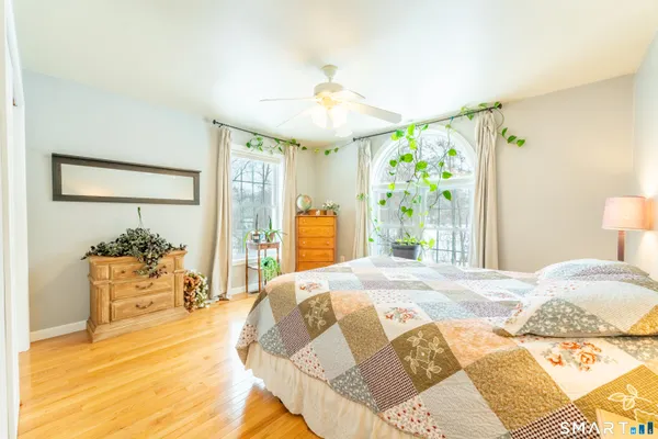 a bedroom with a bed and a chandelier