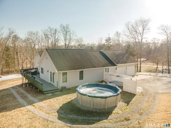 a view of a house with swimming pool and sitting area