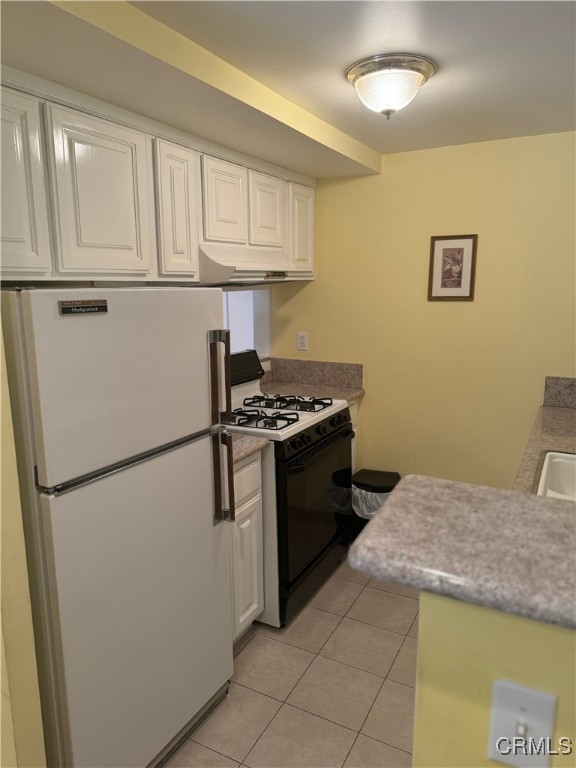 205 Cool Creek Lane Lake Arrowhead, CA 92352 - Photo 7 of 14 a kitchen with a refrigerator and cabinets