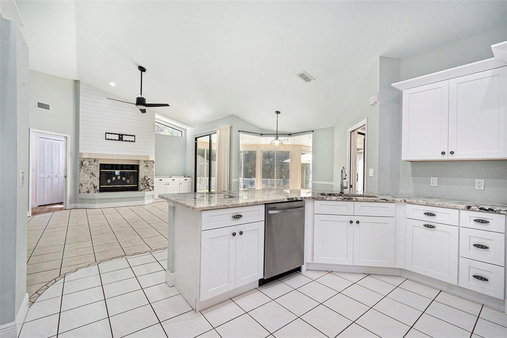 175 Pine Street Homosassa, FL 34446 - Photo 13 of 27 a large kitchen with cabinets and stainless steel appliances