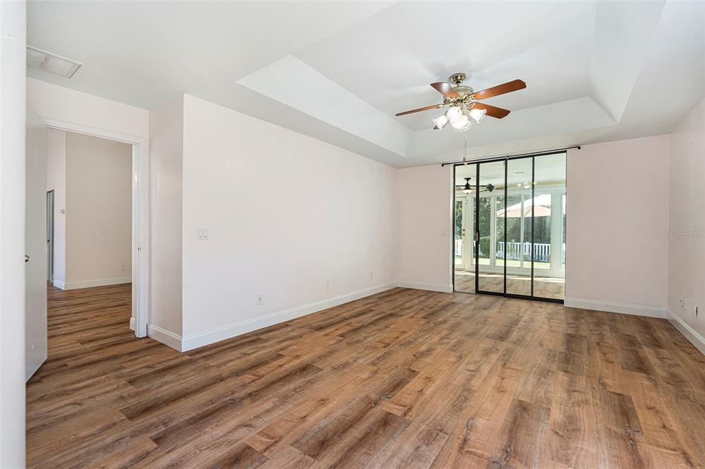 175 Pine Street Homosassa, FL 34446 - Photo 15 of 27 a view of an empty room with wooden floor and a window