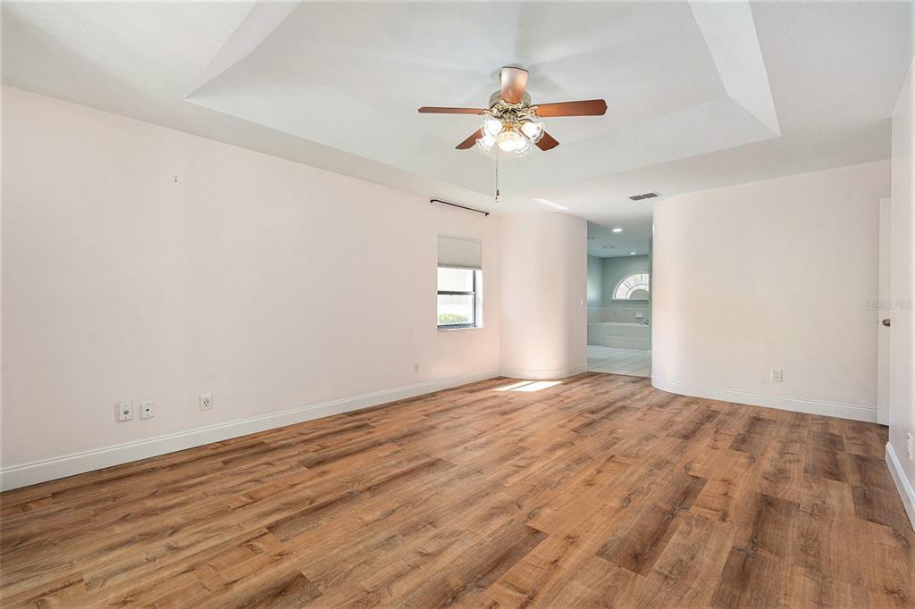 175 Pine Street Homosassa, FL 34446 - Photo 16 of 27 a view of empty room with wooden floor and fan