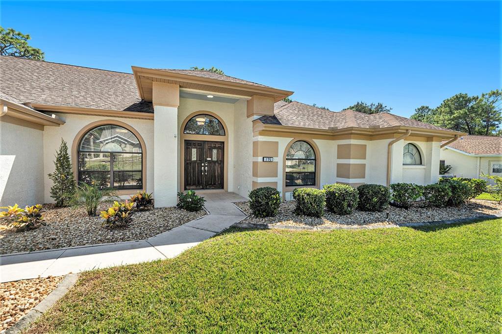 175 Pine Street Homosassa, FL 34446 - Photo 3 of 27 a front view of a house with a porch
