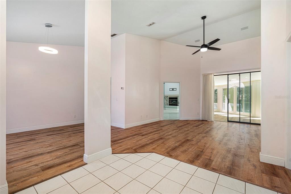 175 Pine Street Homosassa, FL 34446 - Photo 4 of 27 a view of empty room with wooden floor and fan