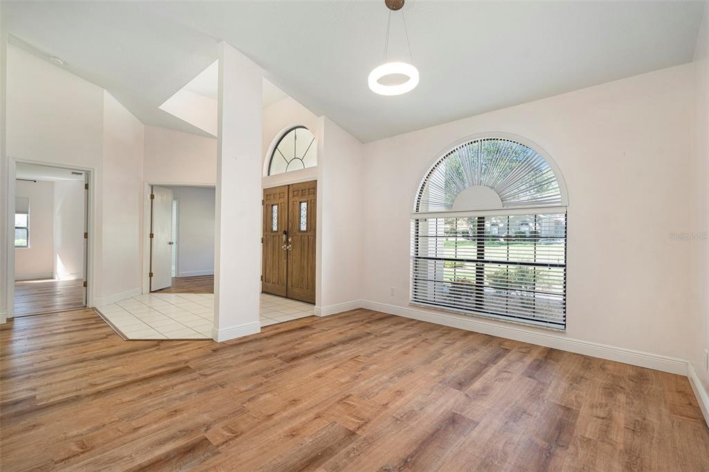 175 Pine Street Homosassa, FL 34446 - Photo 5 of 27 a view of an empty room with wooden floor and a window