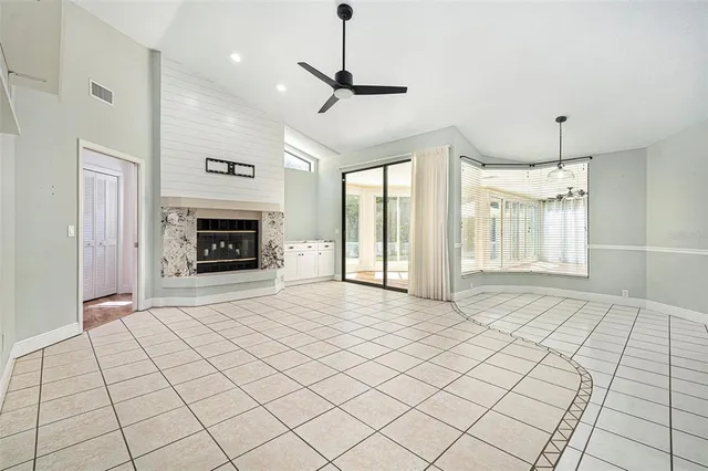 a view of an empty room with a fireplace and a window