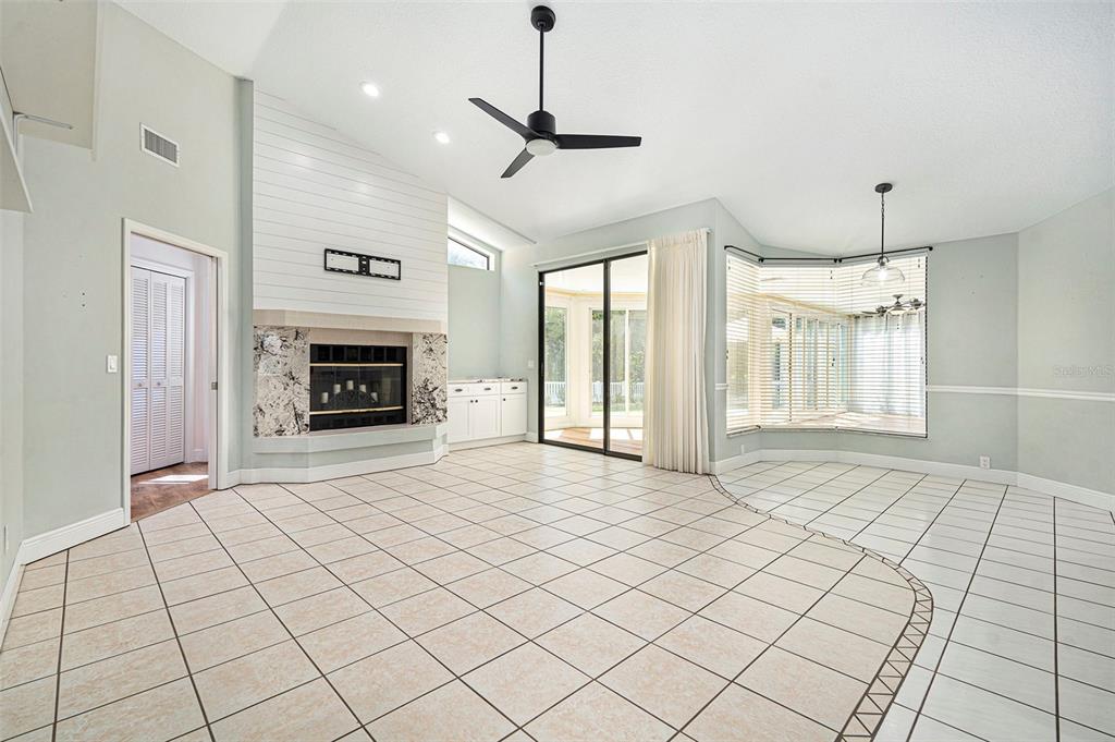 175 Pine Street Homosassa, FL 34446 - Photo 9 of 27 a view of an empty room with a fireplace and a window