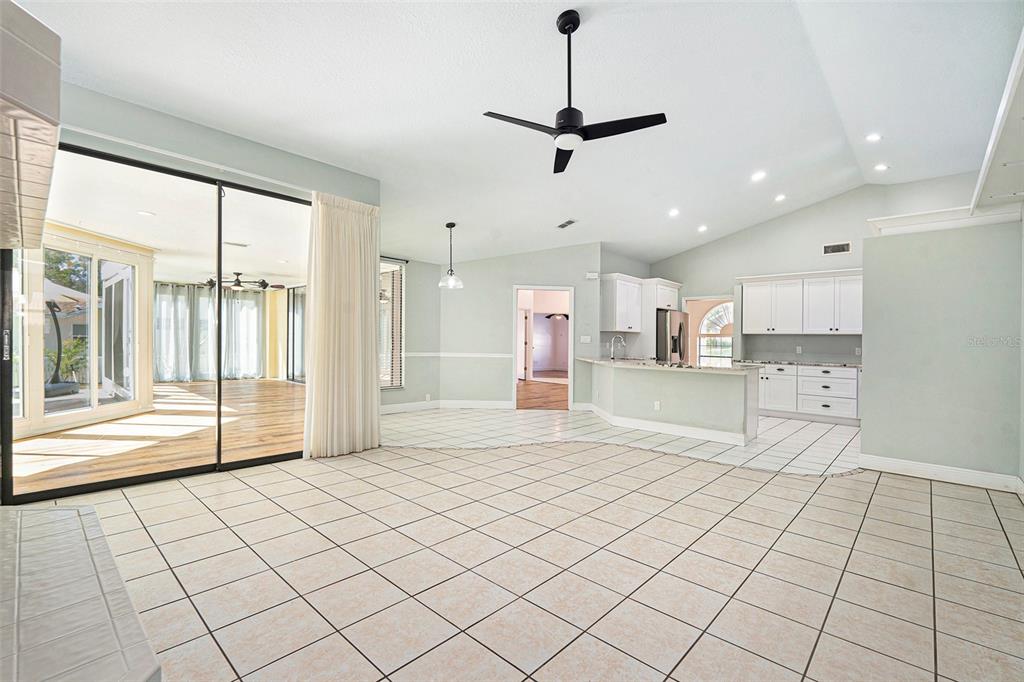 175 Pine Street Homosassa, FL 34446 - Photo 10 of 27 a view of kitchen and empty room with wooden floor