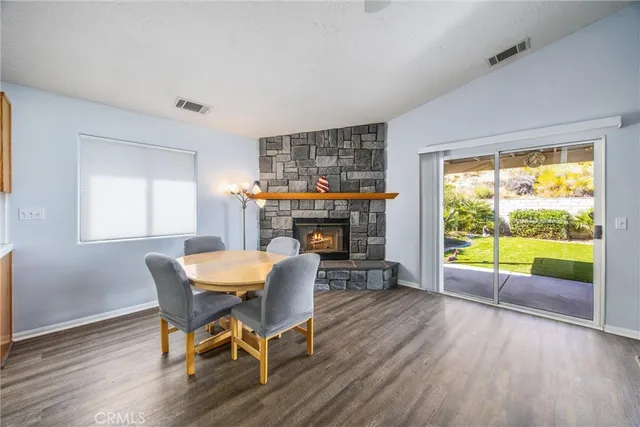 a dining room with furniture wooden floor and a rug