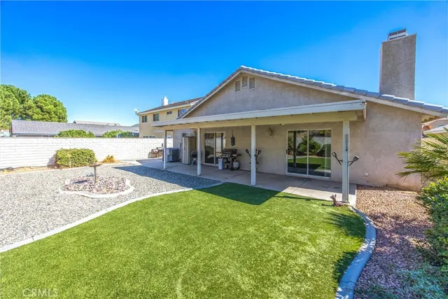 a view of a house with swimming pool and a yard